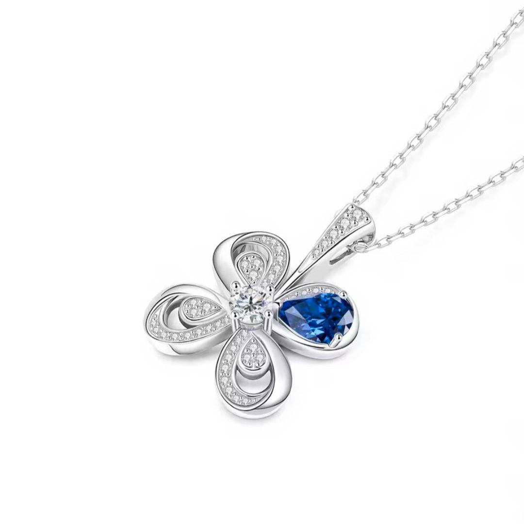 Silver necklace with a blue gemstone pendant on a white background