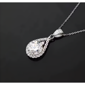 Silver teardrop-shaped pendant necklace on a black background